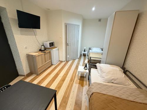 a small living room with a couch and a tv at Noclegi Lebud-bis in Starachowice