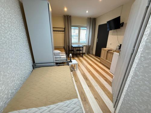 a room with a bed and a living room at Noclegi Lebud-bis in Starachowice