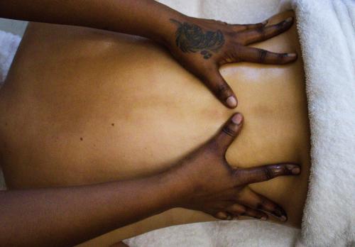 a woman with her hands on her stomach at The Hive - Cloud at Misty Mountain Reserve in Stormsrivier