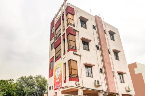 a tall white building with a sign on it at Hotel O Elite Inn in Nagpur