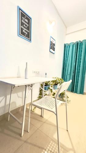 a white desk and a chair in a room at Viik wellness inn -3 Star Resort in Arambol Beach in Arambol