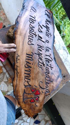 a piece of wood with writing on it at Hostal Portobelo in Portobelo