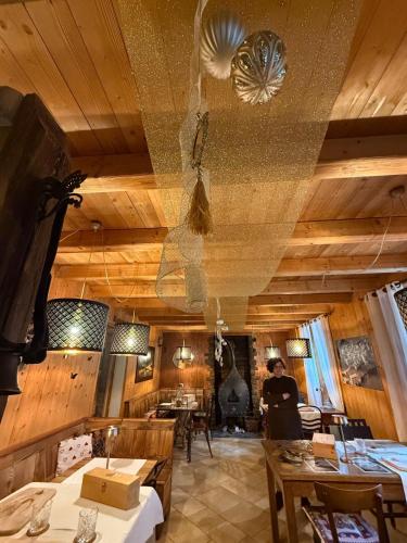 a restaurant with wooden walls and tables and a ceiling at La Locandiera in Carona