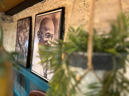 a picture of a man on a wall with plants at The Bridge House in Bridport