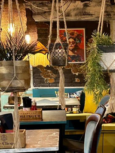 a room with a table and some potted plants at The Bridge House in Bridport
