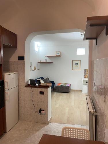 a kitchen and a living room with a refrigerator at Casa Luna in Ventimiglia