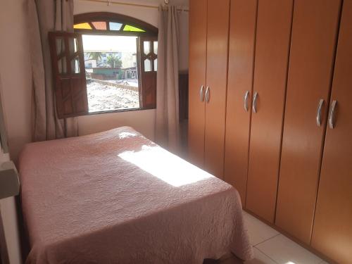 a bedroom with a bed and a window at Sobrado estilo Colonial in Salvador