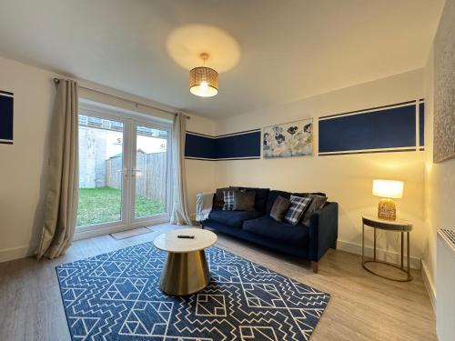 a living room with a couch and a table at Modern 2 Bedroom Home In Central Location with 3 Beds and Free Driveway Parking in Doncaster