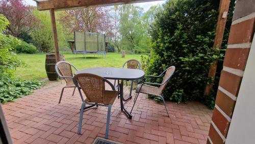 a table and chairs on a brick patio at Hotel Tini in Bad Fallingbostel