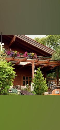 a house with flower boxes on the roof at Landhaus de Gaspary in Seehausen am Staffelsee
