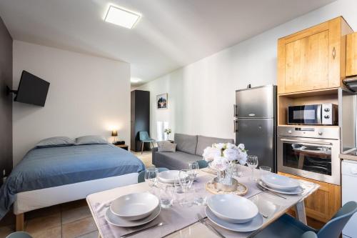 Cette chambre comprend un lit et une table avec des plaques de cuisson. dans l'établissement Laetitsnow Moutiers Ski & Comfort, à Moutiers