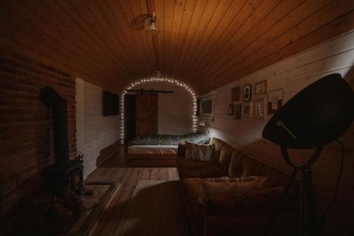 a living room with a couch and a brick wall at Kisvacok tiny house in Kismaros