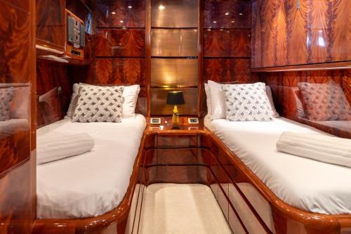 two beds in a boat with a lamp on a table at Super Yacht Located in Puerto Banus in Marbella