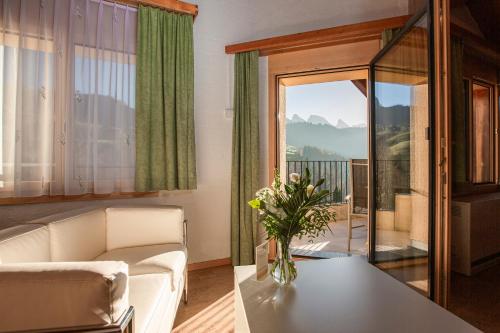 a living room with a couch and a table at Hotel Restaurant Schönau in Wildhaus