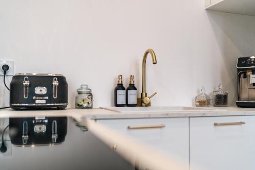 a kitchen with a counter top with a toaster and a toaster at Villamoon Maison vue sur le port et la ville close in Concarneau