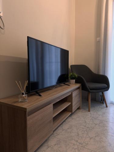a flat screen tv sitting on top of a wooden entertainment center at HERA QUEEN Boutique in Larisa