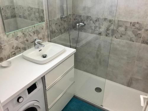 a bathroom with a sink and a shower at Studio vue mer in Sausset-les-Pins