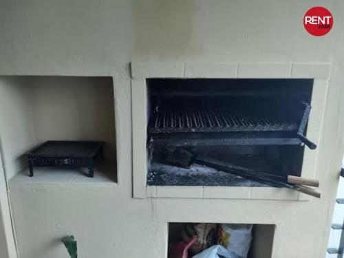 a fireplace with a person taking a picture in it at Rent Mendoza in Buenos Aires