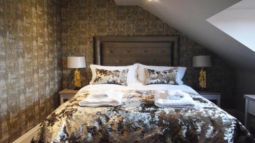 a bedroom with a bed with towels on it at The Lord Street Hotel; BW Signature Collection in Southport