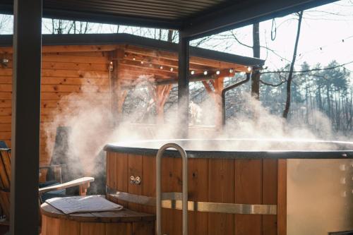 a hot tub with smoke coming out of it at Hiska Na Samem v Slovenj Gradcu in Slovenj Gradec
