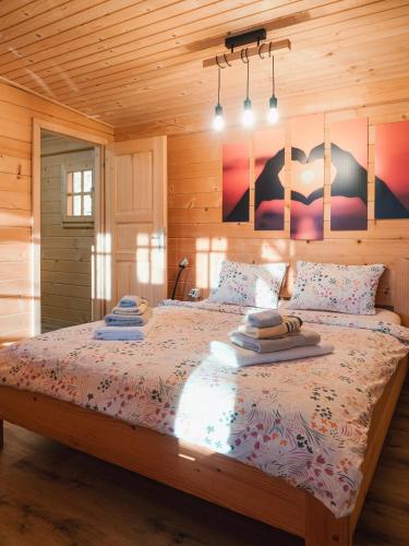 a bedroom with a bed with pillows on it at Hiska Na Samem v Slovenj Gradcu in Slovenj Gradec