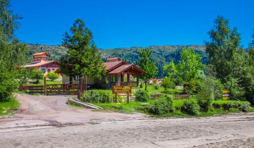 a house on the side of the road at Aires Serranos - Suites in La Cumbrecita