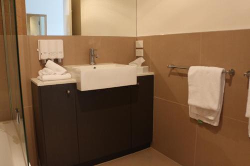 a bathroom with a sink and a mirror at Bairnsdale International in Bairnsdale