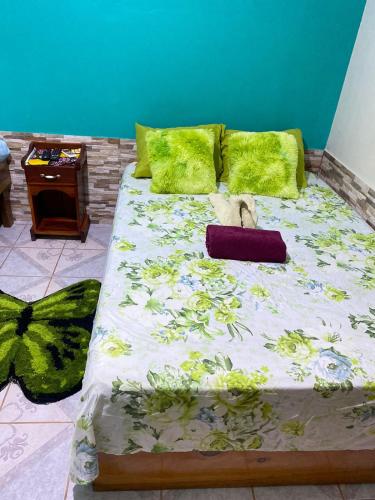 a bed with a stuffed animal sitting on top of it at Cabinas Mitchaelle's in Puerto Viejo