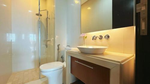 a bathroom with a sink and a toilet and a shower at Straits Quay Highest & Spacious Seaview Suite - 3 in Bagan Jermal