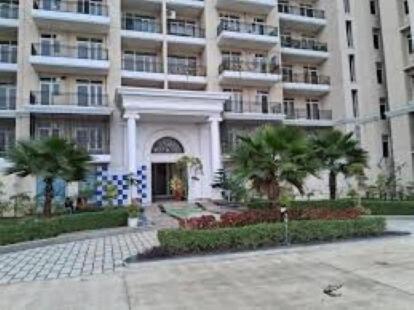 a large apartment building with palm trees in front of it at Best for Mahakumbh 2025! in Prayagraj