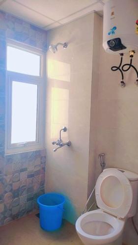 a bathroom with a white toilet and a window at Best for Mahakumbh 2025! in Prayagraj