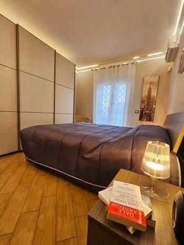 a large bed in a room with a table at Oasi di Greta Suite Home - Fiumicino in Fiumicino