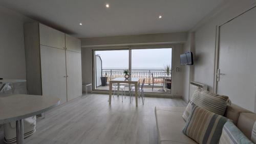 - un salon avec une table et une vue sur l'océan dans l'établissement OCEAN BLEU - front de mer et balcon, à La Baule