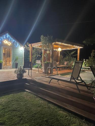 a patio at night with chairs and lights at La case d'Édith in Le Tampon