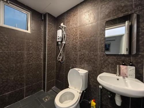 a bathroom with a toilet and a sink at Langkawi Simfoni Luxury Suite 10 in Kuah