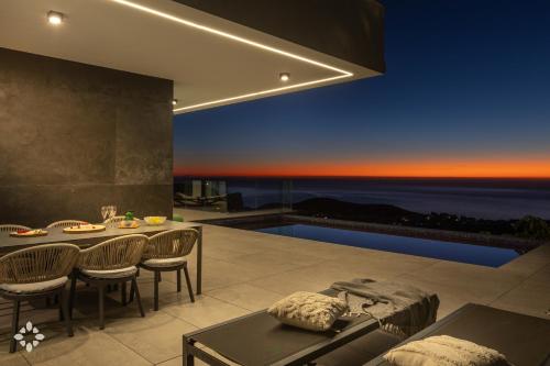 a luxury house with a view of the ocean at Villa Hermes by Abahana Luxe in Benitachell