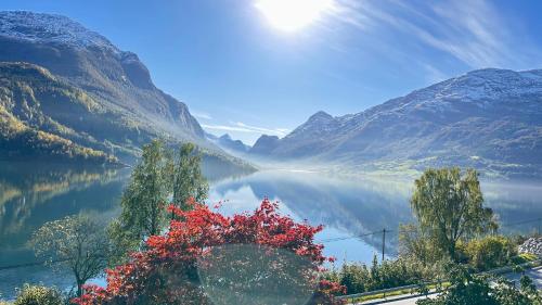 a view of a lake in a valley with mountains at Panorama #CasaSolvik #Loen in Loen