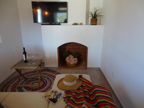 a living room with a hat on the floor at CASA DO POMAR by Stay in Alentejo in Vila Nova de Milfontes