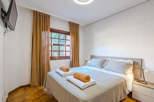 a bedroom with a bed with two towels on it at Sea View Albatros Golf del Sur in San Miguel de Abona