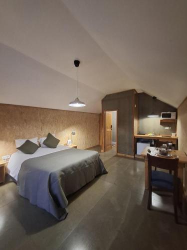 a bedroom with a large bed and a desk at Setubal Apartments in Setúbal