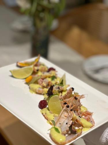 a white plate of food on a table at Avenue Hotel in Ksamil