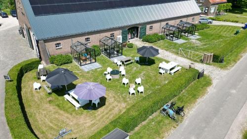 an overhead view of a yard with tables and umbrellas at Hof Olmenstein in Goes