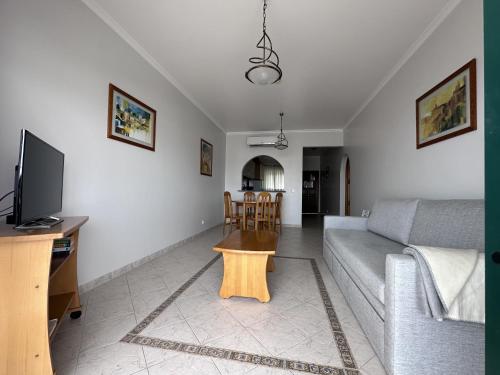 a living room with a couch and a table at BayView Albufeira in Albufeira