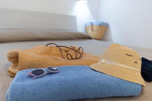 a pair of scissors sitting on a blanket on a bed at Villa Federica by Etra Vacanze in Orosei