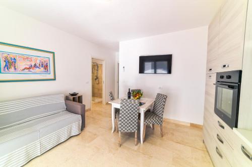 a living room with a table and chairs in a room at Villa Federica by Etra Vacanze in Orosei