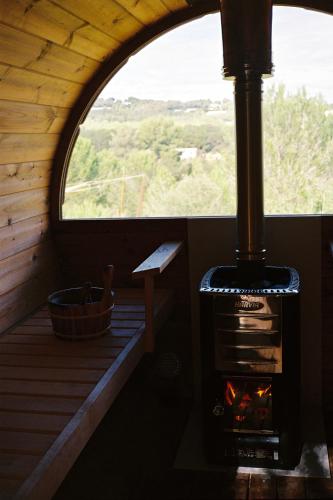 a woodburning stove in a cabin with a window at Aguamadera in Santa Eularia des Riu