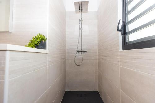 a bathroom with a shower with a black floor at The views from the home were beautiful in Cul de Sac
