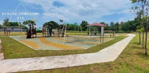 a playground in a park with a playground equipment at Rynurr Homestay A Famosa near Waterpark in Kampong Pulau Sebang