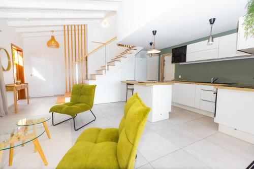 a kitchen and living room with green chairs and a table at The views from the home were beautiful in Cul de Sac