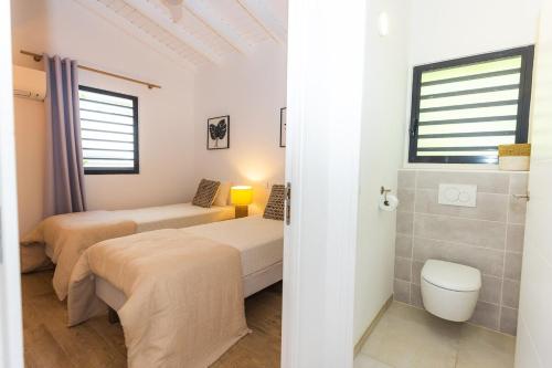 a room with two beds and a toilet in it at The views from the home were beautiful in Cul de Sac